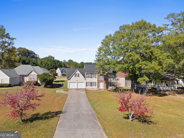 view of front of house with a front yard and a garage