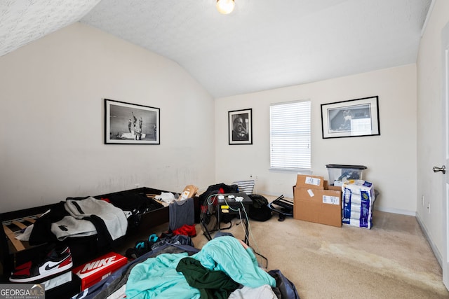 bedroom featuring carpet flooring, a textured ceiling, and vaulted ceiling