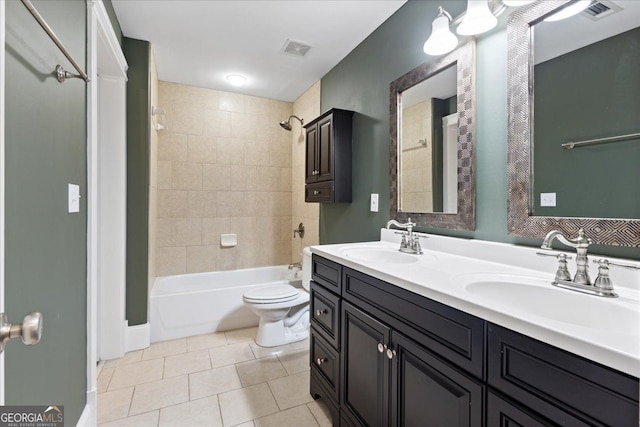 full bathroom with vanity, tile patterned flooring, tiled shower / bath, and toilet