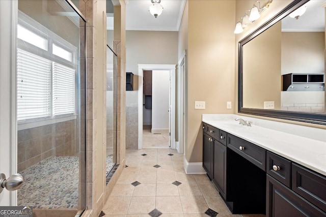 bathroom featuring tile patterned flooring, vanity, crown molding, and walk in shower