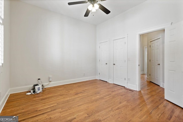 unfurnished bedroom featuring light wood-type flooring and ceiling fan