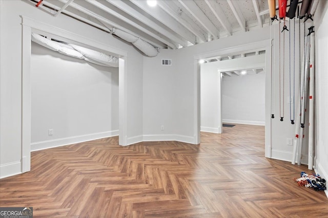 unfurnished room with parquet flooring