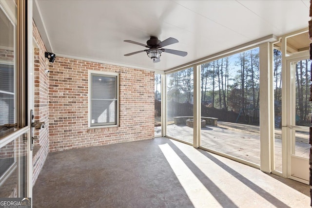 unfurnished sunroom with ceiling fan