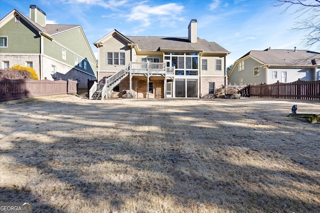 back of house featuring a wooden deck