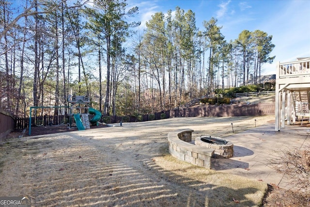 exterior space with a playground and an outdoor fire pit