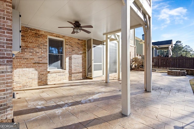 view of patio with a fire pit and ceiling fan