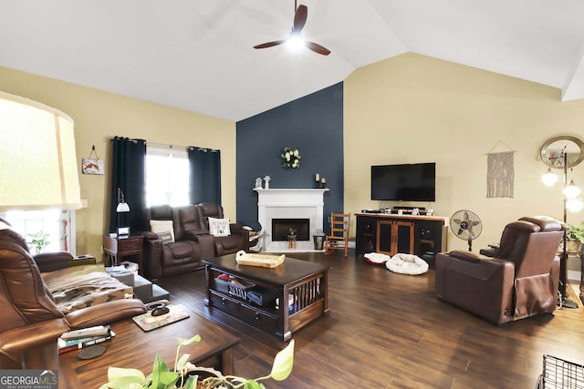 living room featuring vaulted ceiling, ceiling fan, and dark wood-type flooring