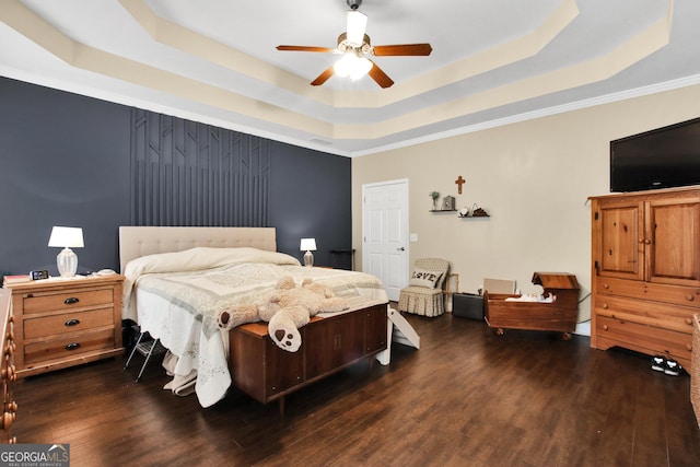 bedroom featuring a raised ceiling, ceiling fan, crown molding, and dark wood-type flooring