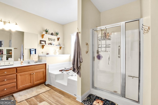 bathroom with hardwood / wood-style floors, vanity, and independent shower and bath