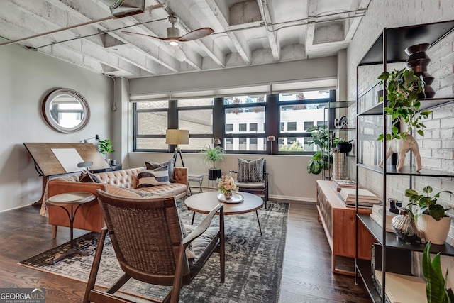 interior space with wood finished floors, a ceiling fan, and baseboards