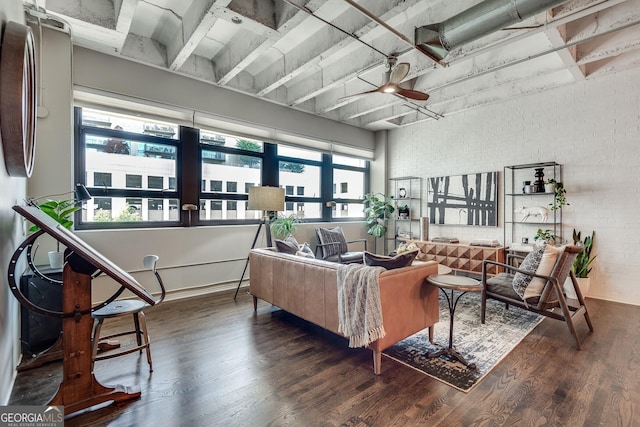 living room with ceiling fan, brick wall, and wood finished floors