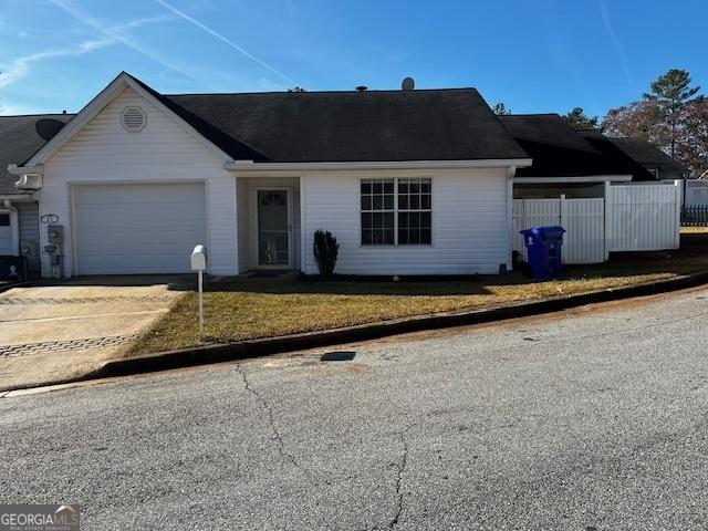 single story home with a front yard and a garage