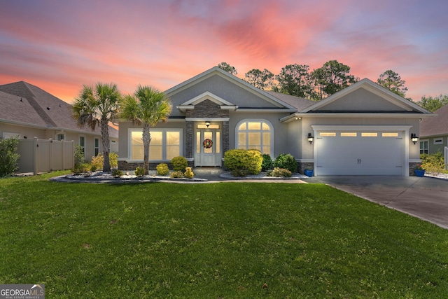 view of front of property featuring a yard and a garage