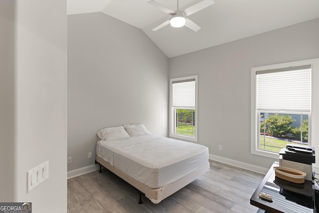 bedroom with light hardwood / wood-style flooring, ceiling fan, and lofted ceiling