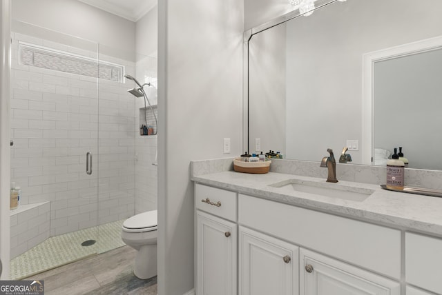 bathroom featuring vanity, toilet, walk in shower, and crown molding