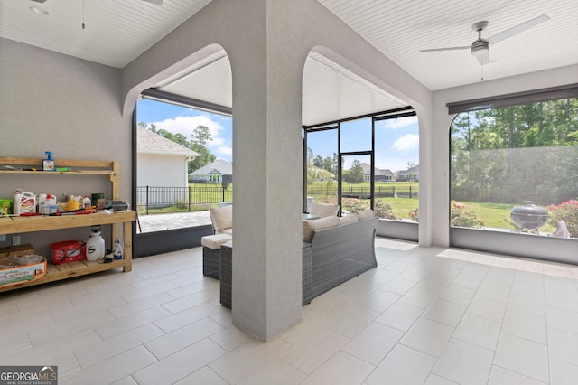 sunroom featuring ceiling fan