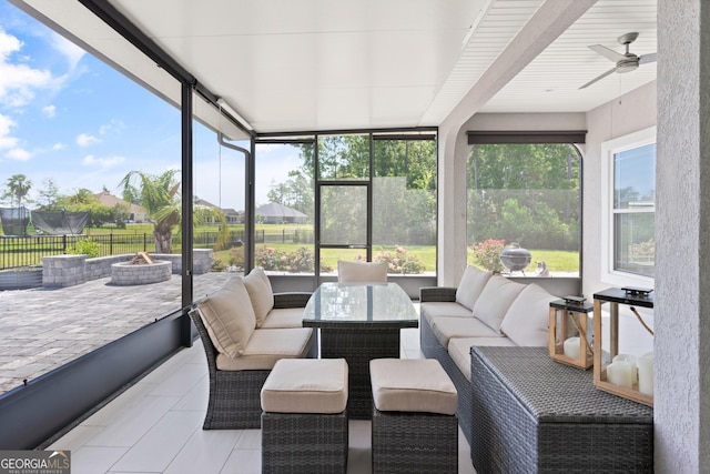 sunroom / solarium featuring ceiling fan