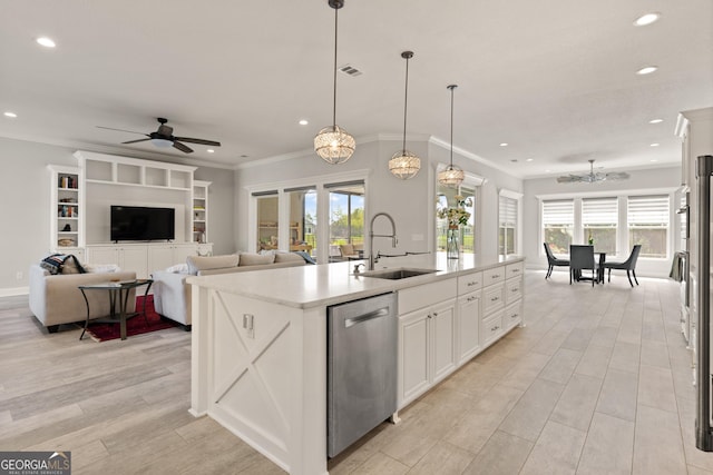 kitchen featuring a kitchen island with sink, ceiling fan with notable chandelier, sink, hanging light fixtures, and stainless steel dishwasher