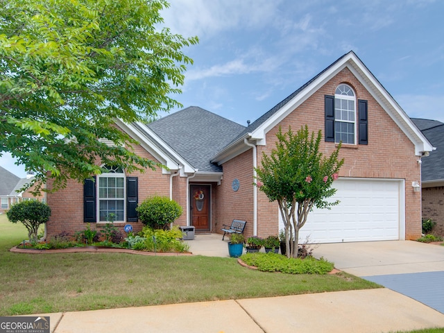 view of front of house with a front lawn and a garage