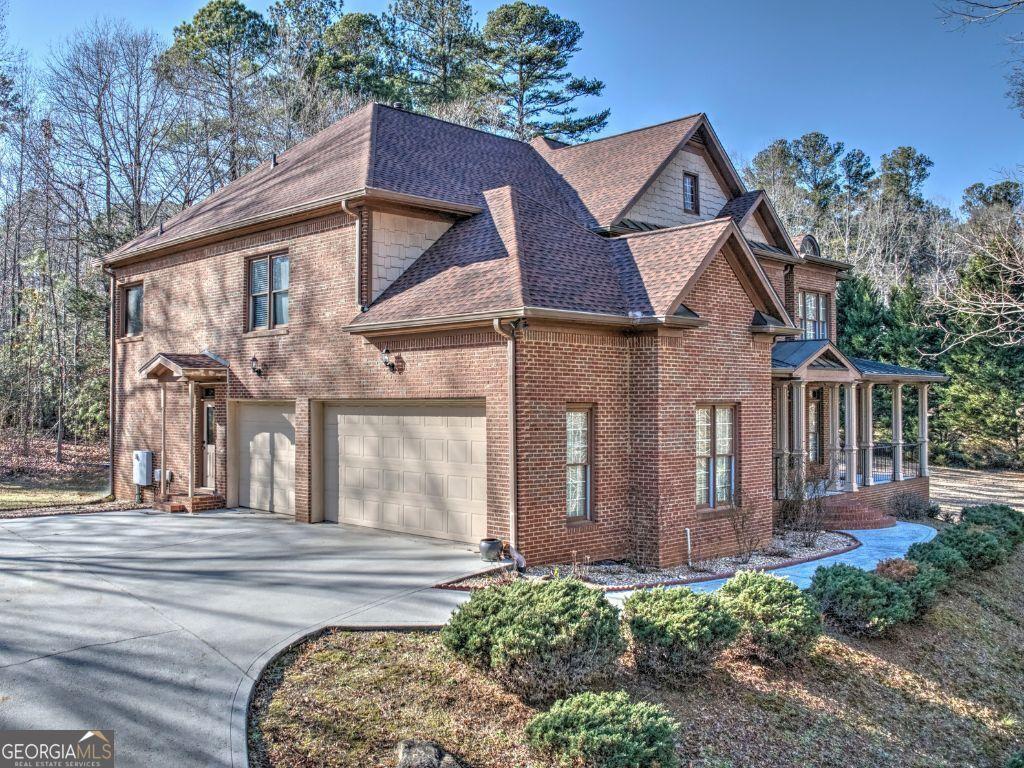 view of side of property featuring covered porch and a garage