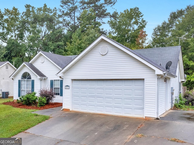 ranch-style home with central AC unit and a garage