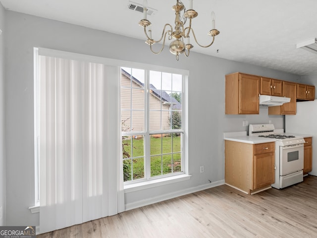 kitchen with pendant lighting, light hardwood / wood-style floors, white range with gas cooktop, and an inviting chandelier