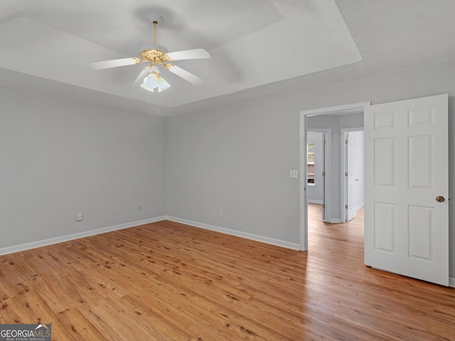 spare room featuring ceiling fan and light hardwood / wood-style flooring