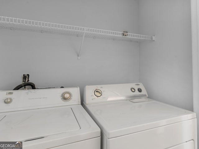 clothes washing area with washing machine and dryer