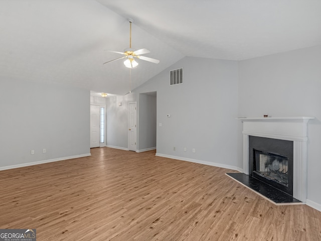 unfurnished living room featuring ceiling fan, light hardwood / wood-style floors, and lofted ceiling