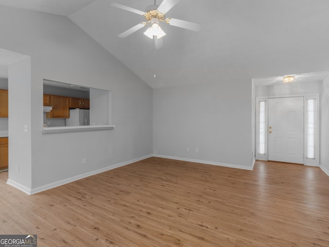 unfurnished living room featuring high vaulted ceiling, light hardwood / wood-style flooring, and ceiling fan