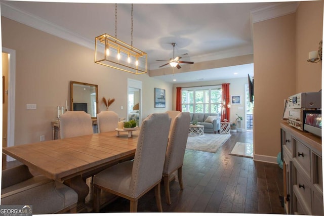 dining area featuring dark hardwood / wood-style flooring, ceiling fan, and ornamental molding