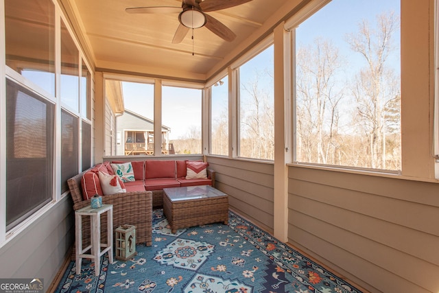 sunroom / solarium featuring ceiling fan