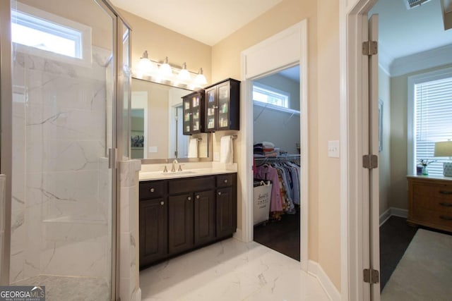 bathroom featuring a wealth of natural light, a shower with door, and vanity