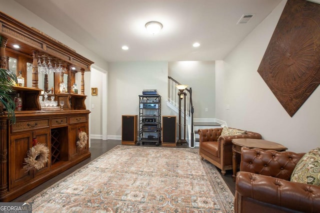 living area featuring a bar, stairway, recessed lighting, and visible vents