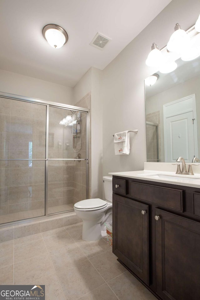 bathroom with visible vents, a shower stall, toilet, tile patterned floors, and vanity