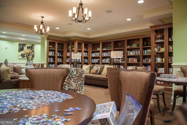 dining area featuring an inviting chandelier, recessed lighting, a tray ceiling, and ornamental molding