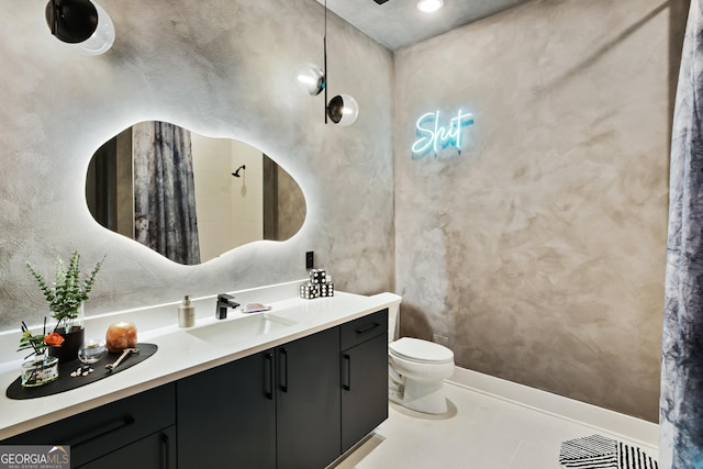 bathroom featuring tile patterned flooring, vanity, and toilet