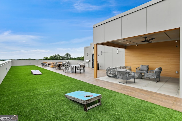 view of yard featuring outdoor lounge area, ceiling fan, and a patio area