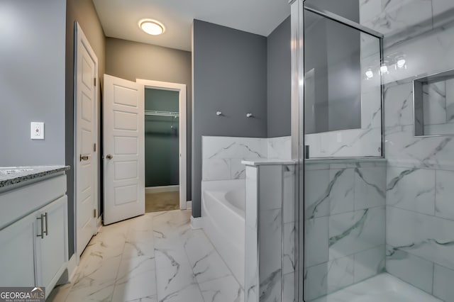 bathroom with vanity and shower with separate bathtub