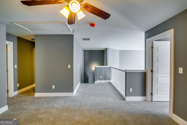 carpeted spare room with ceiling fan