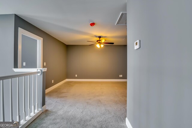 spare room featuring light carpet and ceiling fan
