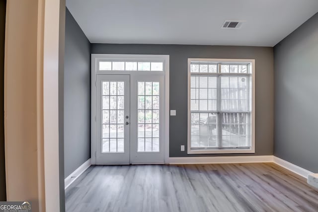 doorway to outside featuring french doors and light hardwood / wood-style floors