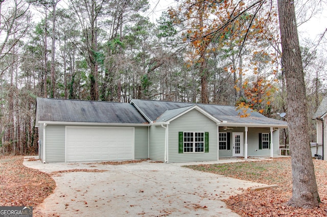 ranch-style house with a porch and a garage