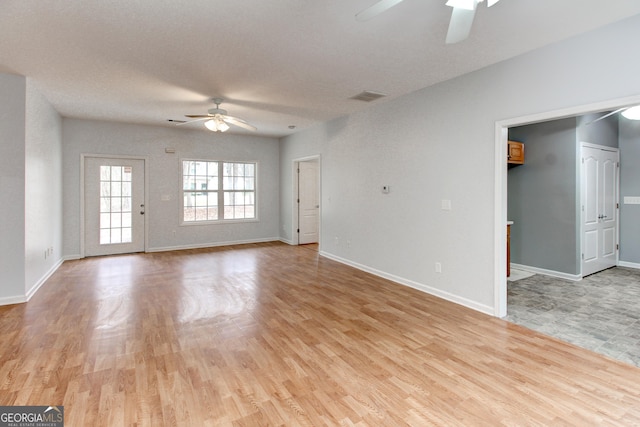 unfurnished living room with light hardwood / wood-style flooring and ceiling fan