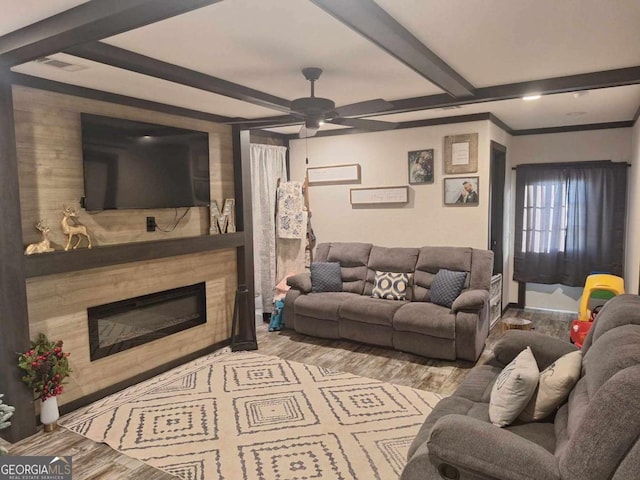 living room featuring beam ceiling, ceiling fan, crown molding, and light hardwood / wood-style floors