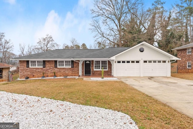 ranch-style house featuring a garage and a front lawn