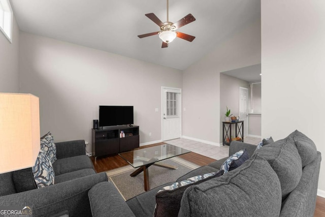 living room featuring ceiling fan, light wood-type flooring, and lofted ceiling