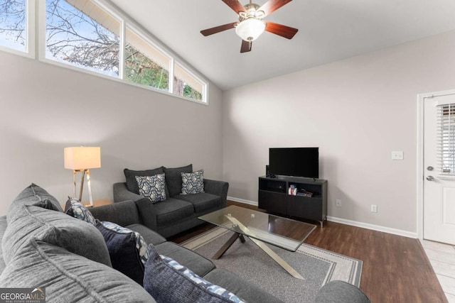 living room with hardwood / wood-style flooring, ceiling fan, and vaulted ceiling