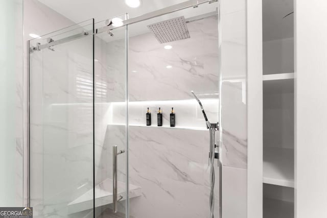 bathroom featuring a shower with shower door