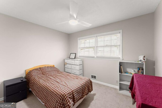 bedroom with ceiling fan and light colored carpet